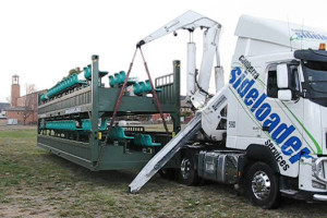 Sideloader lowers portable grandstand to the ground
